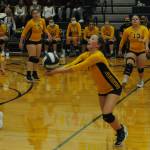 Forks Reagan Dunn hits while Catalina Armas (4), Morgan Rule (9), Nicole Winger (13), and Brynn Daniels (2) look on.