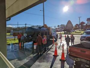 Outside the Clallam Bay Library residents wait to get water from a PUD water truck. Submitted Photo