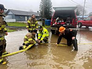 Ive seen fire and Ive seen rain
Clallam County Fire Protection District #1 was called out on Sunday to deal with an abundance of water over the roadway near 2nd Avenue.
With the help of Engine 91s crew and a large pumper off of Tanker 91, it took about 4 hours to clear the street and surrounding houses of most of the large mass of water that was left from recent rains. Photo CCFD1