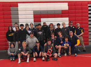 Courtesy of Forks High School The Forks boys and girls wrestling teams celebrate their second-and fourth-place trophies at the Tony Saldiver Invitational held in Granger on Saturday.