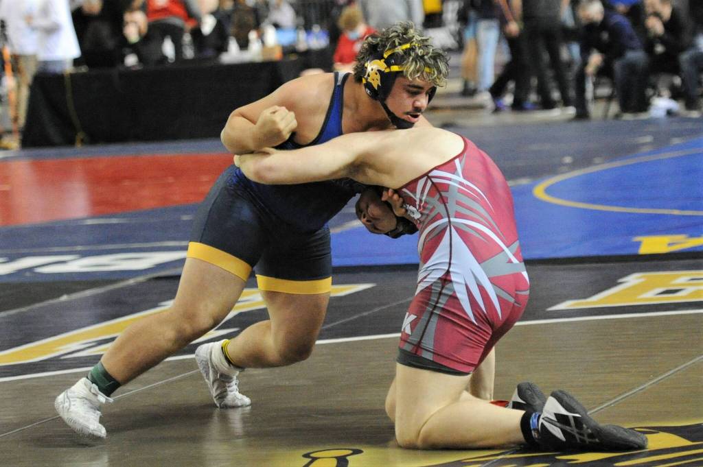 Above right: Sloan Tumaua (left) at 220 lbs came in 4th at state.