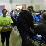 Senior class members were kept busy taking items through the crowd for a closer look …Aspen Rondeau displays a handblown glass river rock …valued at $500.