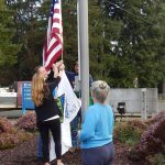 Deborah Dillon looks on as the Flag was raised by Eric Anderson, Kelly Thompson, and Jason Dabney. Photos Christi Baron