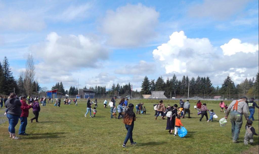 Egg hunting got underway under sunny skies at Tillicum Park at 11 a.m. sharp as Forks Police Chief Mike Rowley gave everyone the Go over his vehicles PA system. Only a few hours later and these egg hunters would have been hunting in the snow, hail, and rain. Photo Christi Baron