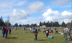 Egg hunting got underway under sunny skies at Tillicum Park at 11 a.m. sharp as Forks Police Chief Mike Rowley gave everyone the Go over his vehicles PA system. Only a few hours later and these egg hunters would have been hunting in the snow, hail, and rain. Photo Christi Baron