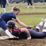 Spartan Kaidence Rigby tags the runner out at first.