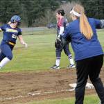 Spartan coach Traci Kratzer waves Kyra Neel around third with a home run.
