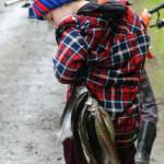Seven-year-old Wyatt Stonebreaker checks to see if his fish are still hanging over his shoulder as he leaves with his limit.