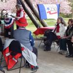At the podium Master of Ceremonies Marianne Burton, with Michael Trebert DAR, welcomed about 30 people to the American Elm dedication on Friday afternoon at Tillicum Park. Seated at the front are (L-R) Cynthia Bork, Shirley Lorentz, Rod Fleck, and General George Washington. Washington was quite entertaining! Photos Christi Baron