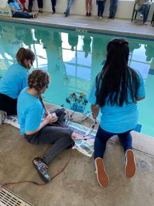 Students watch as their ROV enters the water at the Forks Athletic and Aquatic Center (FAAC). Submitted photos