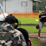 Bailey Johnson of the Scrap Yard Dawgs pitches against the Charge Saturday in the rain and mud. Photo by Lonnie Archibald