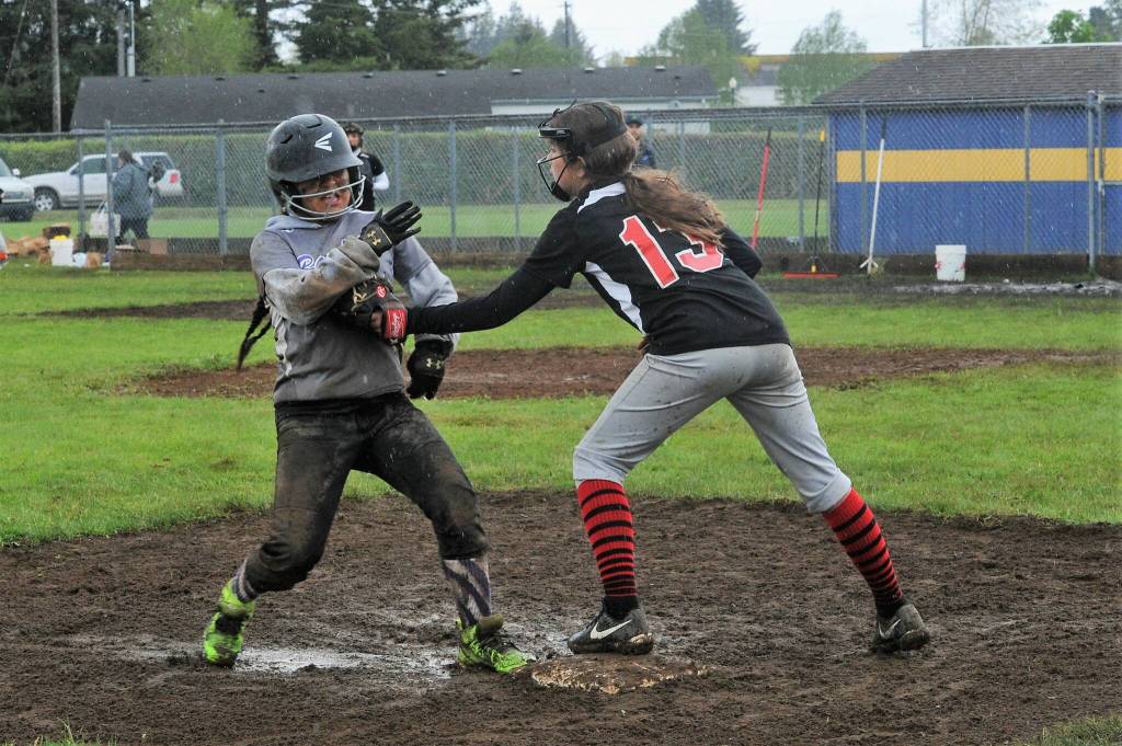 Scrap Yard Dawgs third baseman Pearl Salazar tags Bandits runner Sarah Sifuentes out at third. Scrap Yard won the Kenny Church softball championship by defeating the Bandits. Photo by Lonnie Archibald