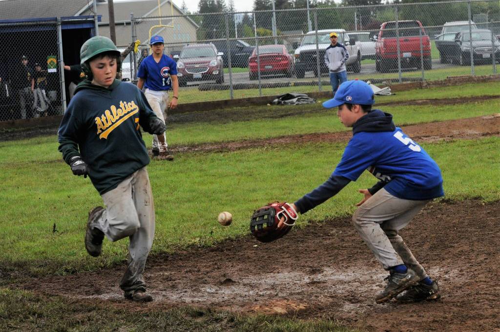 As runner Tannon Gaydeski was safe at first as Cubs first baseman Daniel Pressley took the throw. The Cubs won the championship in a close 4 to 3 contest in the Kenny Church baseball Tournament played at Duncan Field Sunday. Photo by Lonnie Archibald