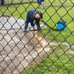 When mother nature gives you rain … get out the Shop-Vac! Danny Winger is seen here Saturday morning vacuuming the field. Later Winger was seen wearing a life jacket. Photo Christina Jennings