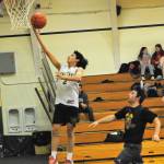 Forks Aiden Salazar lays the ball up for two points Thursday evening in the Spartan auxiliary gym where the Spartans outscored the Loggers in this scrimmage contest.