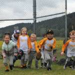 The Pirates rush onto the field to take their positions. Well, some took their positions only with help from the coaches. At times they might end up with two or three shortstops with no second or third baseman but those in charge soon got that situation straightened out.These future Spartans soon had it figured out, however, and all was well. Well sort of anyway. Oh yes, and the catcher, far left, was carrying too heavy of a load to be running with the team so he took time out to adjust his chest protector. Photo by Lonnie Archibald
