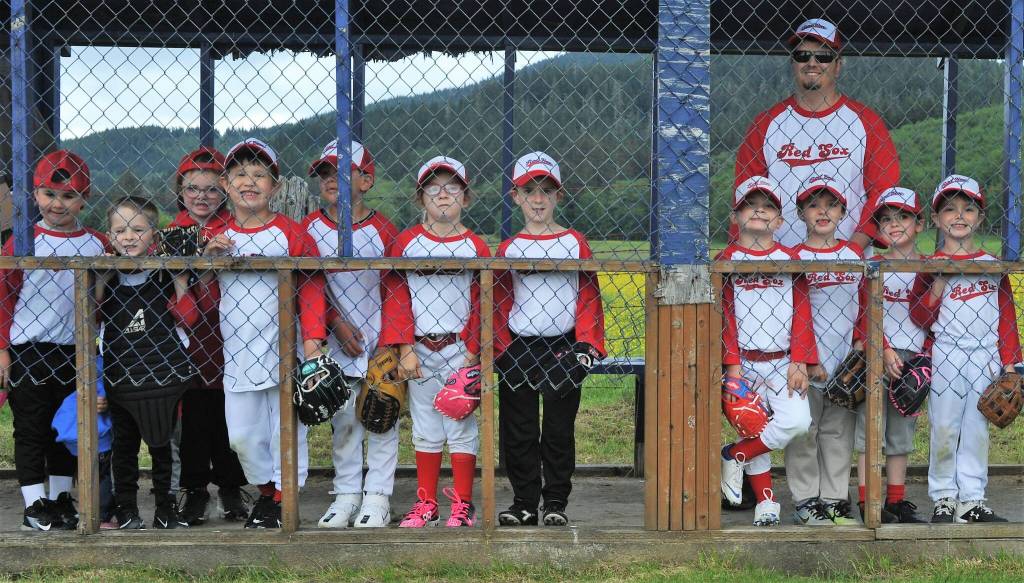 The Red Sox awaited quietly in the dugout watching for the rain which never came. Yes, that is correct, no rain. Photo by Lonnie Archibald