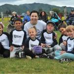 The Wildcats took time to pose for the media after their pre-game meeting here at Duncan Field. In the background parents, grandparents, mothers, fathers, uncles, and aunts along with cousins and siblings await the big game. Photo by Lonnie Archibald