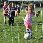 With teammates looking on, Henley Gagnon of the Red Dragons connects for the score. Photo by Lonnie Archibald
