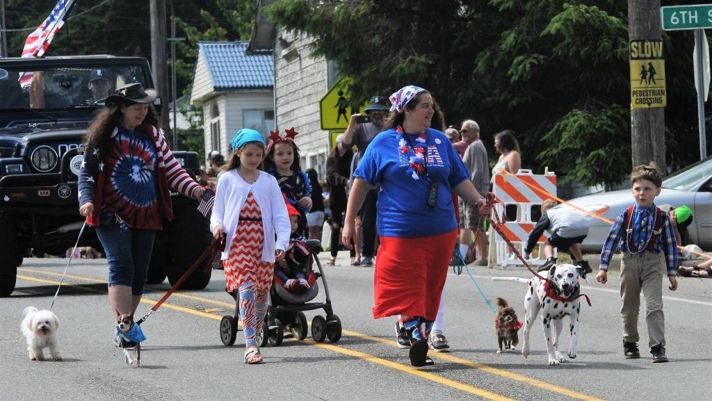 The Belzak/Crawford family of Beaver enter the parade as United We Stand along with their colorful Dalmatian which besides its black spots received some colorful paintings of blue, red and more. Photo by Lonnie Archibald