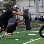 Tweleve-year-old Jeremiah McPherson teamed up with coach Trevor Highfield moving the sled downfield here at Spartan Stadium.