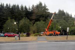 Last Wednesday the City of Forks Public Works Crew worked to put new lighting at the Gold Star Families Memorial at the Forks Transit Center. At about 11:15 a.m. it got so dark that the street lights at the Transit Center have come on, just before some thunder, lightning, and rain. Volunteers had previously dug trenches and installed the needed wiring. Photo Christi Baron