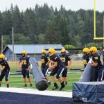 Spartan head coach Trevor Highfield runs players through drills on the turf at Spartan Field Aug 23 in preparation of the upcoming season.