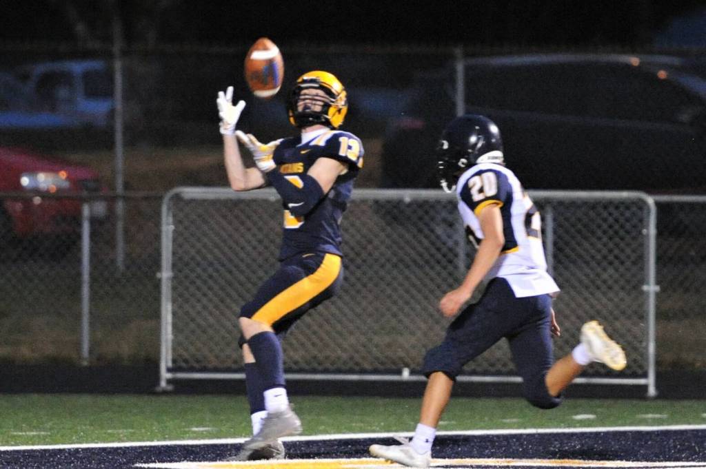 Spartan Ryan Rancourt (13) pulled in this Gunner Rogers pass for a TD which was called back due to a Spartan penalty. This was one of two Forks penalties that took touchdowns off the scoreboard. Forks went on to defeat Ilwaco 49 to 6, however. photo by Lonnie Archibald