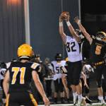 Forks Landin Davis (5 ) defends against this Ilwaco pass to Robert Sanders. Looking on is Spartan Kaleb Blanton (71). Photo by Lonnie Archibald