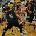 Estevan Ramos (2) drives the key. Also in on the action for Forks are Emanuel Hernandez (20) and Titus Rowley.