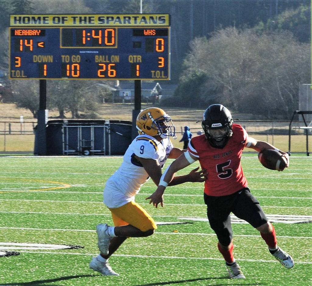 Neah Bays Julian Carrick (5) attempts to avoid the tackle of the Wellpinit defender.