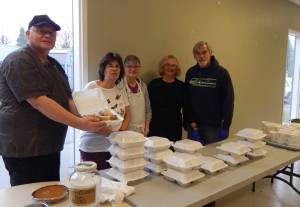 Feeding 5000 volunteers provided 135 Holiday meals to go last Tuesday; turkey, ham, stuffing, mashed potatoes and gravy, and dessert were on the menu. Volunteers seen here are Eugene Fraker, Debbie Anderson, Christie Stallman, Sherry Schaff, and Pastor Bob Schwartz. Other volunteers not pictured are Don Grafstrom, Ohm-Rin Fraker, Ashley Debriae, Todd McGrail, Diane Gaydeski, and Edith Henry. Photo Christi Baron