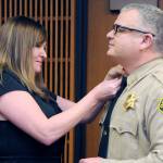 Incoming Clallam County Sheriff Brian King, right, receives his sheriff star from his wife, Brenda King, after he was sworn into office by Superior Court Judge Lauren Erickson on Wednesday at the Clallam County Courthouse. (Keith Thorpe/Peninsula Daily News)