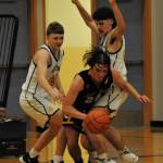 Spartans Landen Olson (left) and Dylan Micheau defend against North Beachs Kobe Charley in this league contest won by Forks 58 to 21. Photo by Lonnie Archibald