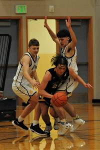 Spartans Landen Olson (left) and Dylan Micheau defend against North Beachs Kobe Charley in this league contest won by Forks 58 to 21. Photo by Lonnie Archibald