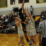Spartans (from left) Ryan Rancourt, Brandon Galeana and Kaleb Callaghan defend against Hyak Tyrell Hovland in the closing moments of this contest won by Forks over North Beach. Photo by Lonnie Archibald
