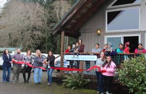 Staff members and clients celebrated the new Forks office - First Steps Family Support Center with a Forks Chamber of Commerce Ribbon Cutting last Friday. Holding the Big Scissors are Chamber Executive Director Lissy Andros and Elisia Anderson, Executive Director for First Steps. Photo Christi Baron.