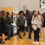 Students mingled about the tables where potential employers shared information about current and future employment opportunities.