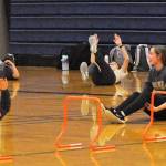 Seen here is just a portion of the 52 athletes turning out for track and field as they warm up in the Spartan gym where temperatures were much warmer than those out on the track. Photo by Lonnie Archibald