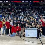 The Neah Bay girls basketball team celebrates winning the 1B state championship Saturday night in Spokane. (Bridget Mayfield/for the Peninsula Daily News)
