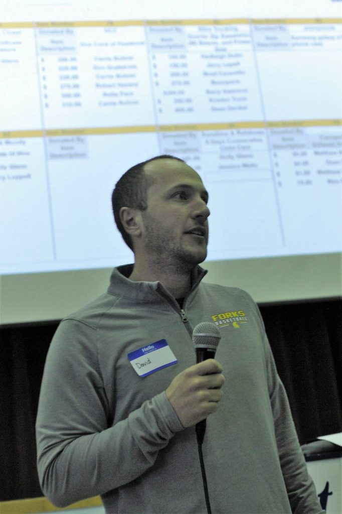 David Hurn makes an announcement during the Scholarship Auction Saturday. Photo by Lonnie Archibald