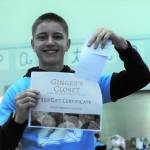Senior Klayton Helvey displays a $50 gift certificate for Gingers Closet. Photo by Lonnie Archibald