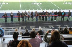 Spectators in the stands photograph the Forks Chamber of Commerce Ribbon Cutting Ceremony with cell phones during the Spartan Stadium dedication held on April 14 at the new Spartan Stadium in Forks. Photo by Lonnie Archibald