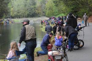 A good-sized crowd of young fishermen along with parents, grandparents, and various family members and friends gave their advice on how to reel in the popular game fish. Photo by Lonnie Archibald