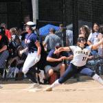 Spartan Kaidence Rigby reaches for the throw to first in a close play called safe by the base umpire.