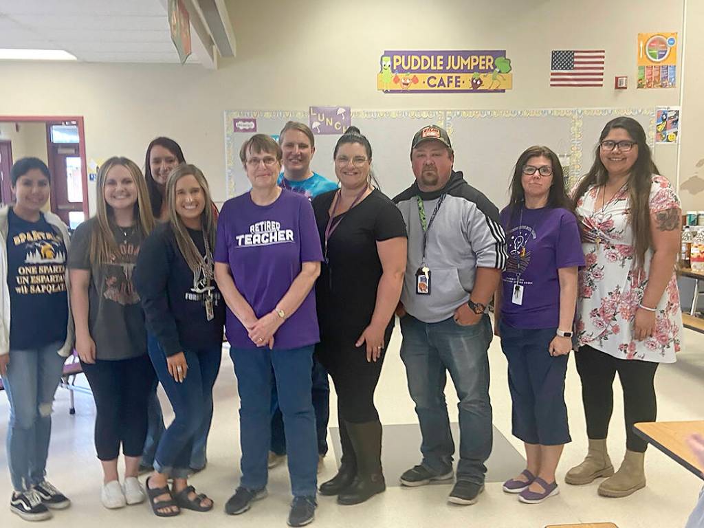 April Tuttle (Forks Elementary School teacher of 42 years) with former students who are now working for QVSD: (From left to right) Maria Barragan (ECEAP Lead Teacher); Alex Jacobson (Kindergarten Teacher); Jaelyn Wilson (ECEAP Asst. Teacher); Kendra Salazar (Para-Educator); April Tuttle (4th Grade Teacher); Cassie Romberg (FES Office Coordinator); Sarah Warner (4th Grade Teacher); Robert Warner (Para-educator); Nichole Johnson (3rd Grade Teacher); and Mercedes Flores (2nd Grade Teacher). Submitted Photos