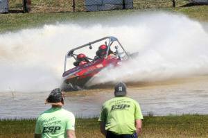 The Fear Not sprint boat driven by Clint Birch and navigated by Terri Lovell speeds through the Extreme Sports Park course as a pair of island hopper safety crew members watch the action earlier this year in Port Angeles. (Keith Thorpe/Peninsula Daily News)
