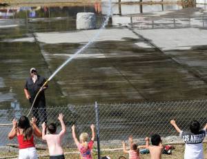 This was the only action at the arena on the 4th as kids asked to be sprayed with water while the arena floor was being watered down prior to what was to be the annual Demolition Derby. The derby was canceled, however, as emergency vehicles were called out to a large brush and structure fire along Bogachiel Way in Forks. Photo by Lonnie Archibald