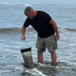 Anthony Odell, UW ONRC, sampling HABs at Kalaloch Beach, using a phytoplankton net.