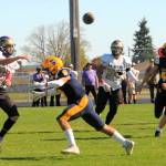 Spartans Kade Highfield (9) and Nate Dahlgren (40) apply pressure on the Wolverine QB causing an inadvertent pass Saturday afternoon in Sequim where Forks defeated Friday Harbor 40 to 6 in this non-league contest. Photo by Lonnie Archibald.
